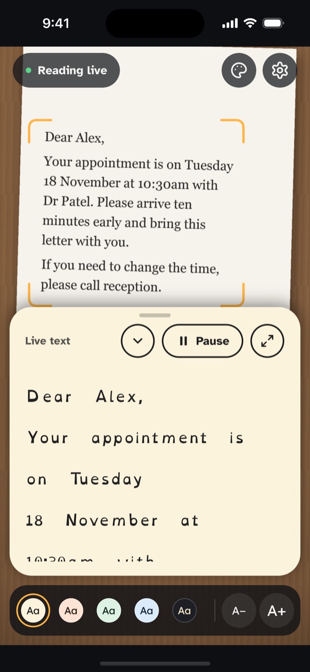 Dyslexia Glasses reading a letter through the camera, shown in a cream reading window